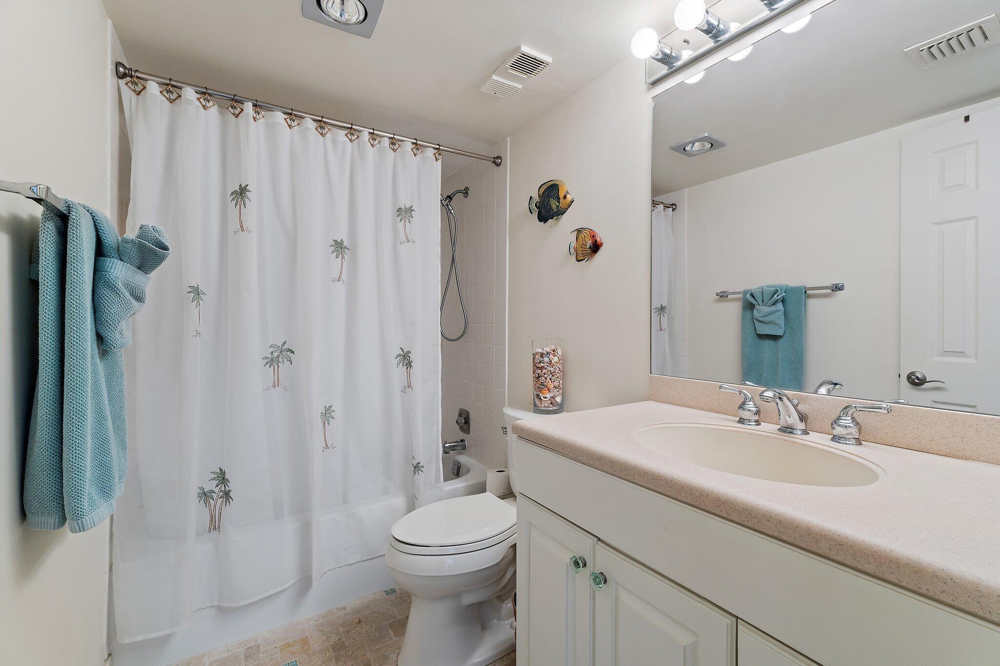 300 Ocean Trail Way, Unit 403 Jupiter, FL 33477 - Photo 27 of 50 a bathroom with a sink a toilet and shower