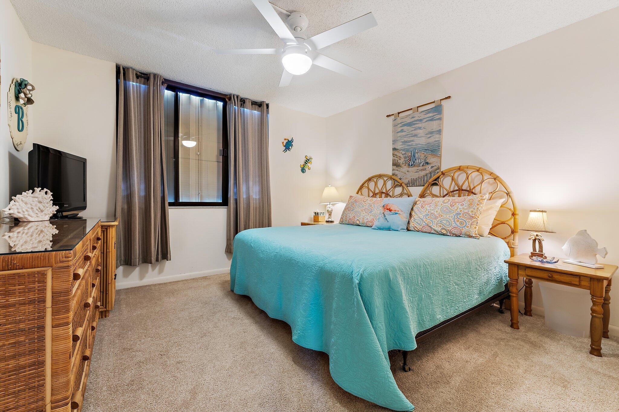 300 Ocean Trail Way, Unit 403 Jupiter, FL 33477 - Photo 28 of 50 a bedroom with a bed and a flat tv screen on dresser