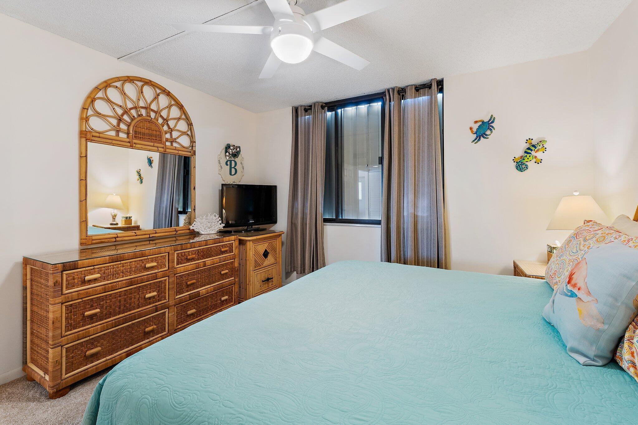 300 Ocean Trail Way, Unit 403 Jupiter, FL 33477 - Photo 29 of 50 a bedroom with a bed and a mirror on dresser