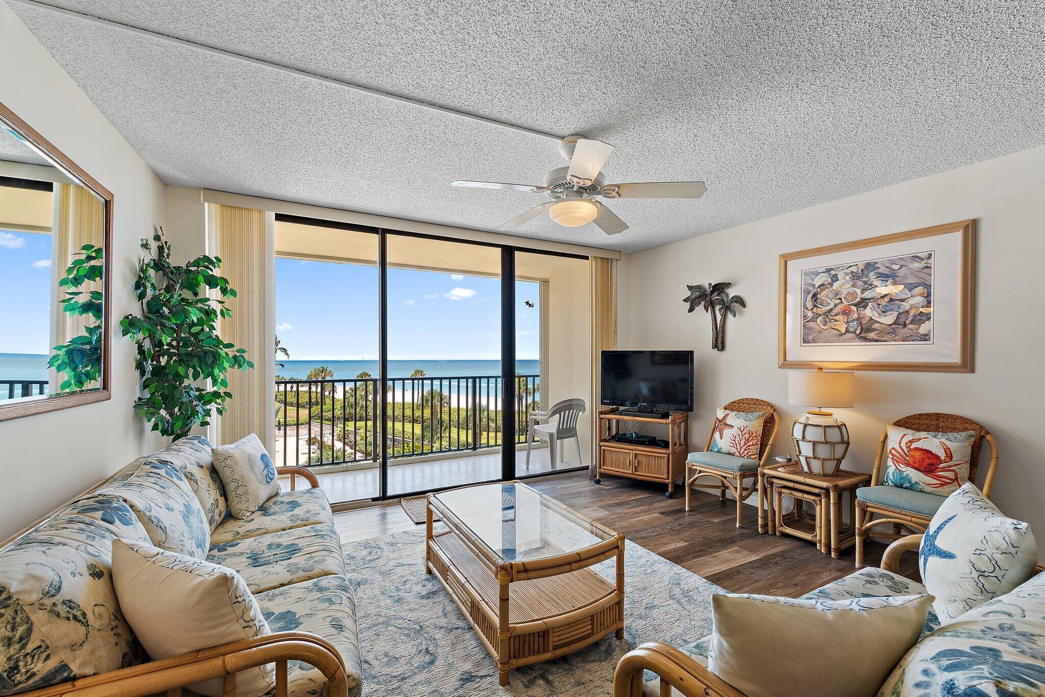 300 Ocean Trail Way, Unit 403 Jupiter, FL 33477 - Photo 10 of 50 a living room with furniture and a large window