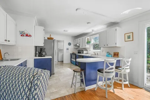 a kitchen with stainless steel appliances kitchen island granite countertop a sink and cabinets