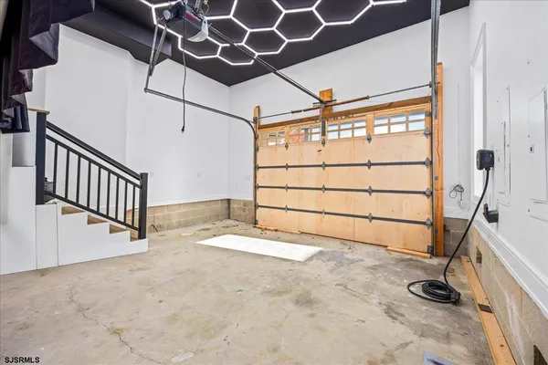 a view of empty room with wooden floor and windows