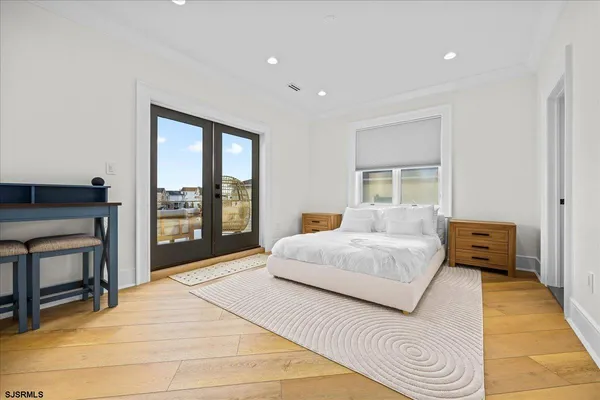 a bedroom with a bed and a large window