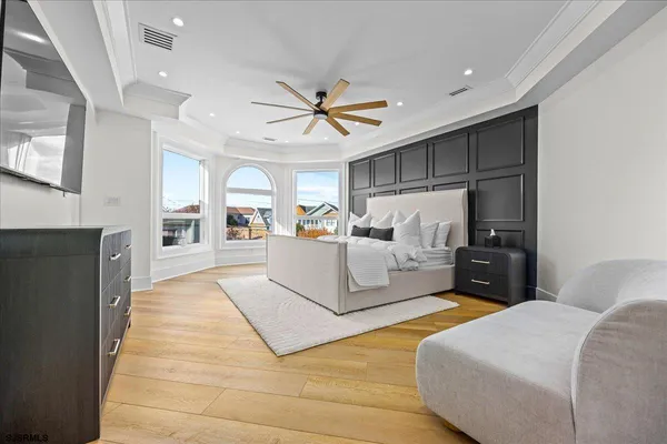 a bedroom with a bed and a large window