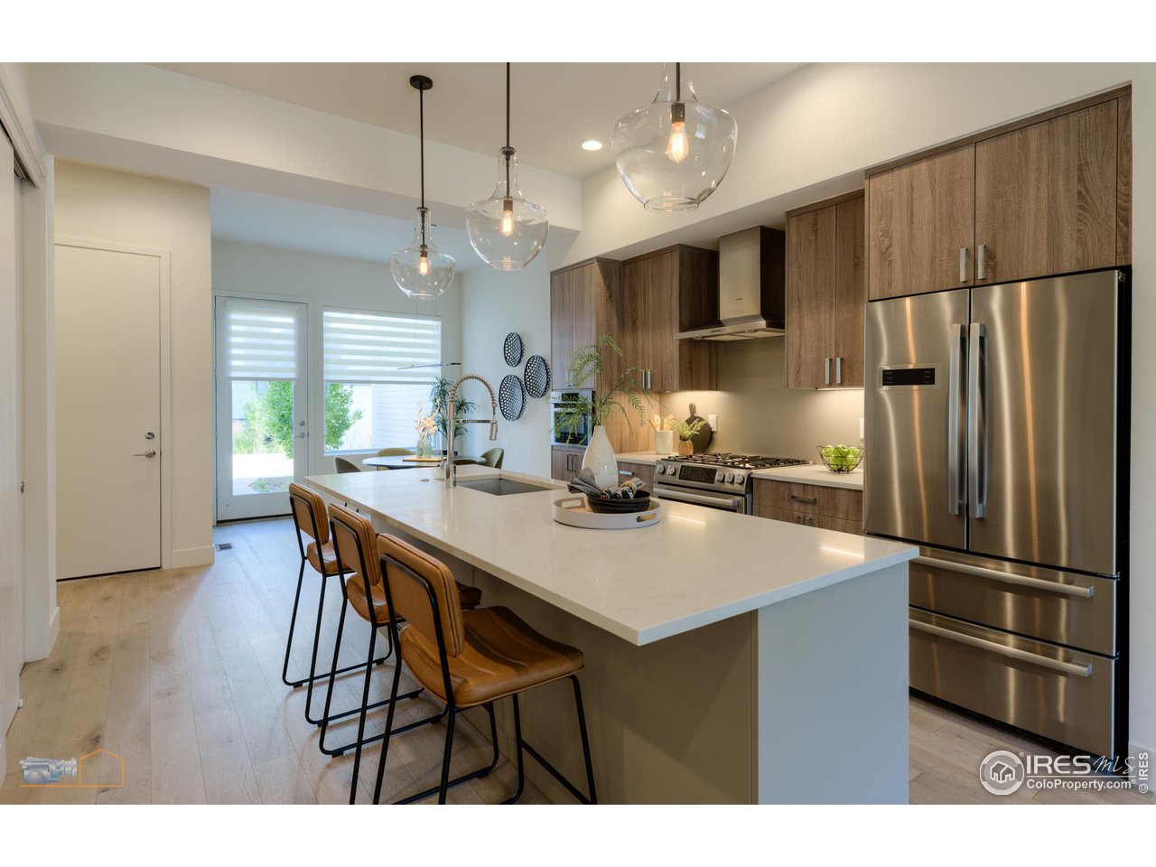 3105 Bluff Street Boulder, CO 80301 - Photo 10 of 40 a kitchen with stainless steel appliances a dining table chairs and refrigerator