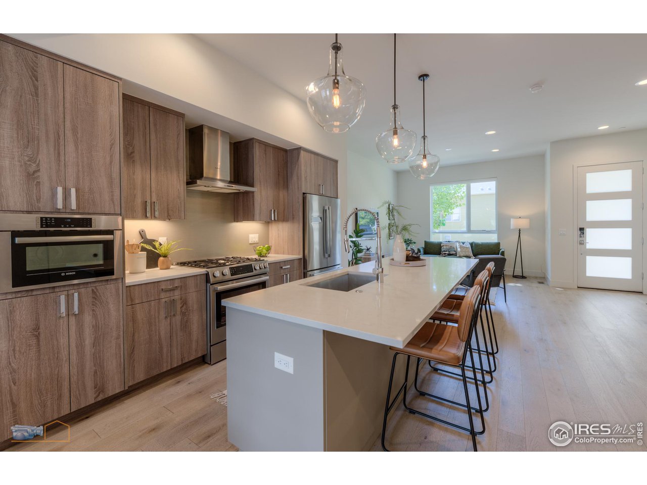 3105 Bluff Street Boulder, CO 80301 - Photo 16 of 40 a kitchen with a table chairs refrigerator and microwave