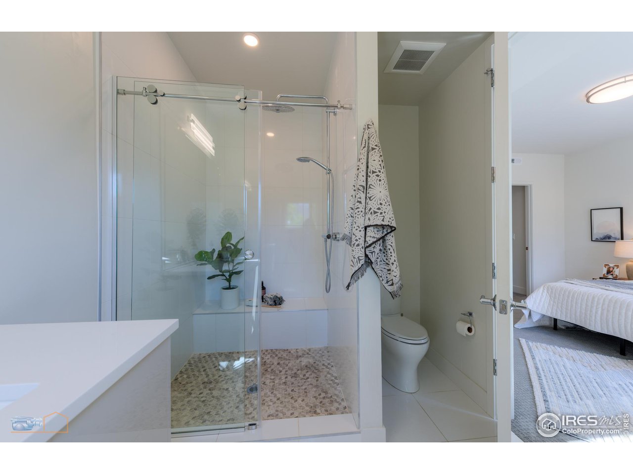 3105 Bluff Street Boulder, CO 80301 - Photo 21 of 40 a bathroom with a granite countertop sink a toilet and shower