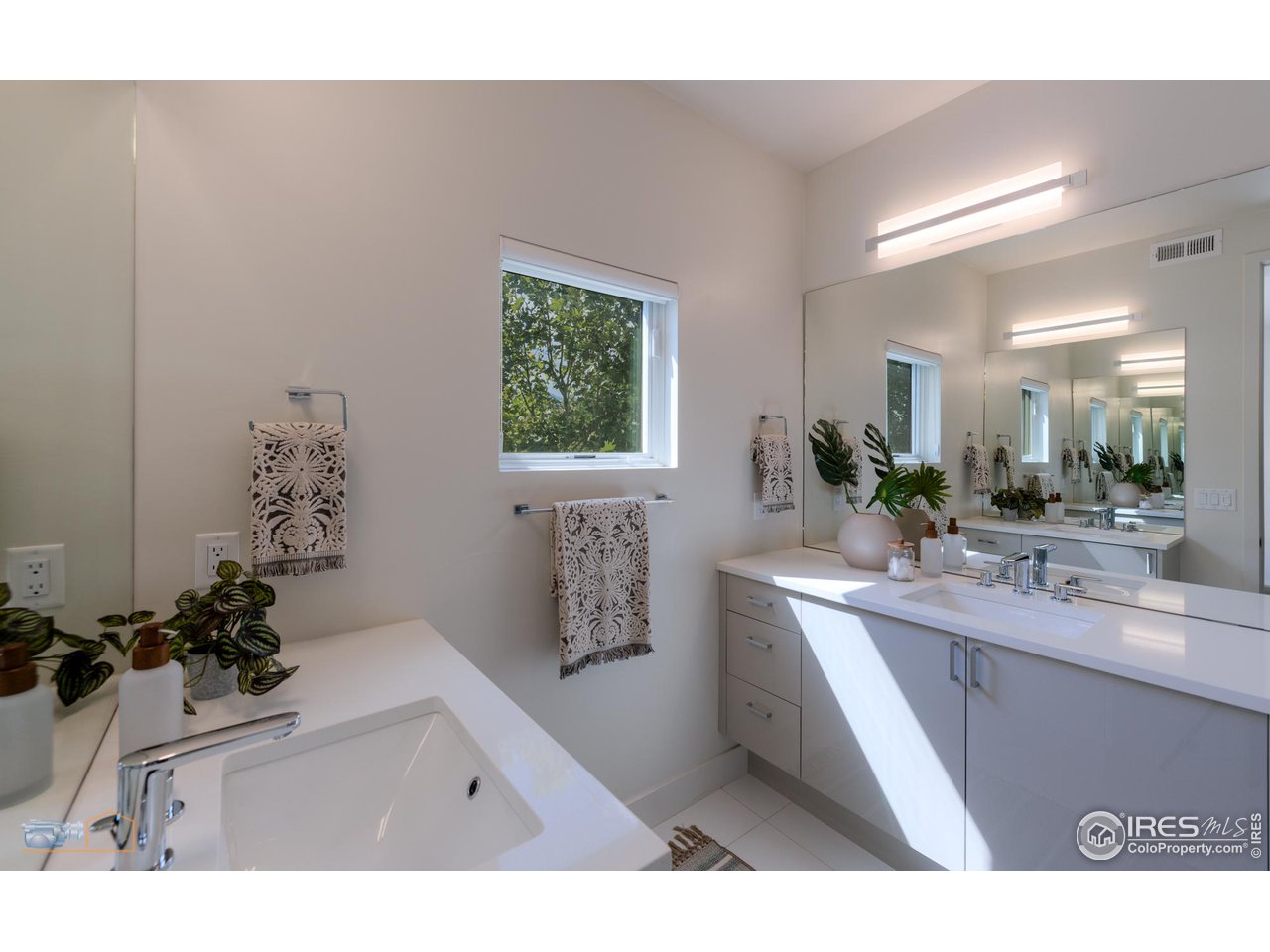 3105 Bluff Street Boulder, CO 80301 - Photo 22 of 40 a bathroom with a sink a mirror and a potted plant