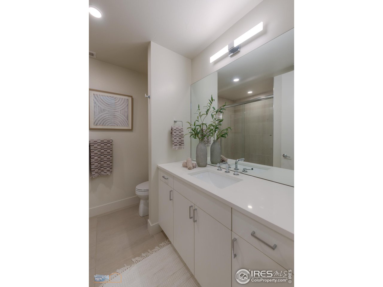 3105 Bluff Street Boulder, CO 80301 - Photo 26 of 40 a bathroom with a toilet a sink and mirror