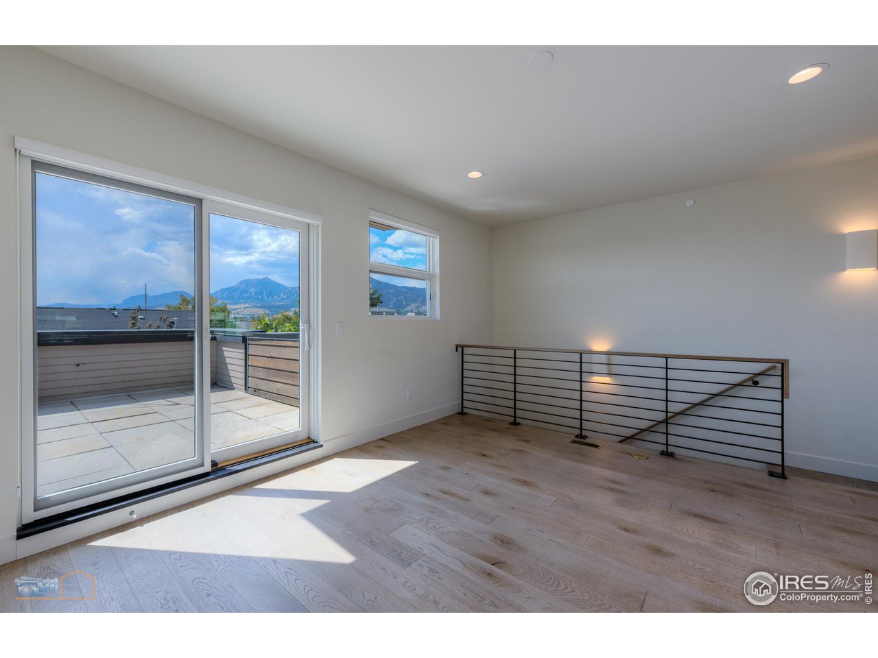 3105 Bluff Street Boulder, CO 80301 - Photo 33 of 40 a view of an empty room with wooden floor and windows
