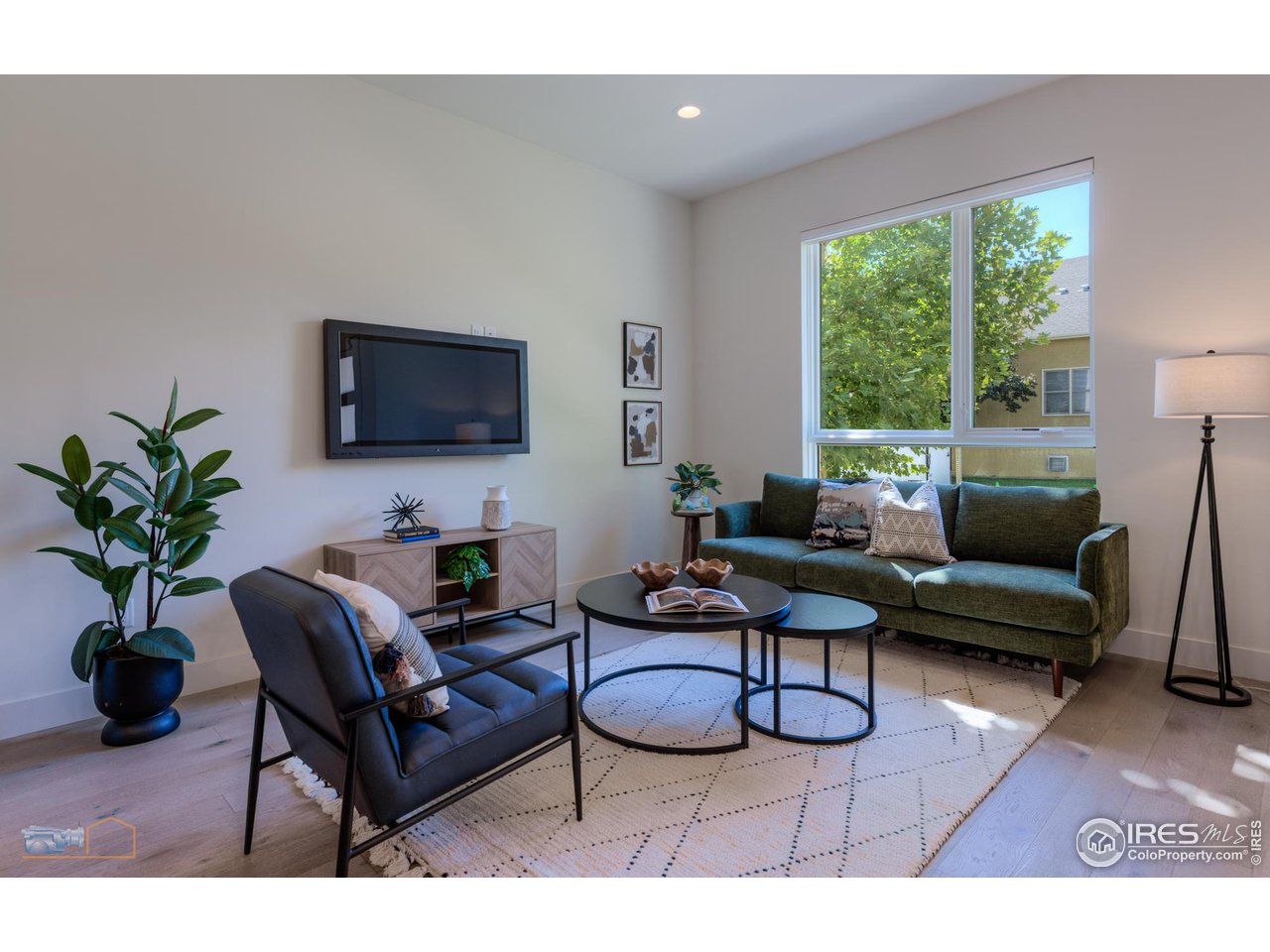 3105 Bluff Street Boulder, CO 80301 - Photo 39 of 40 a living room with furniture a flat screen tv and a potted plant
