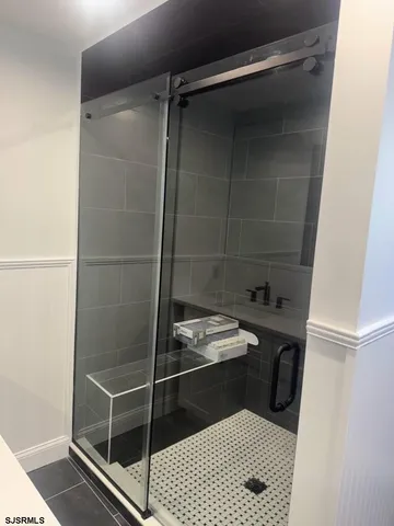 a room with a washing machine and a shower