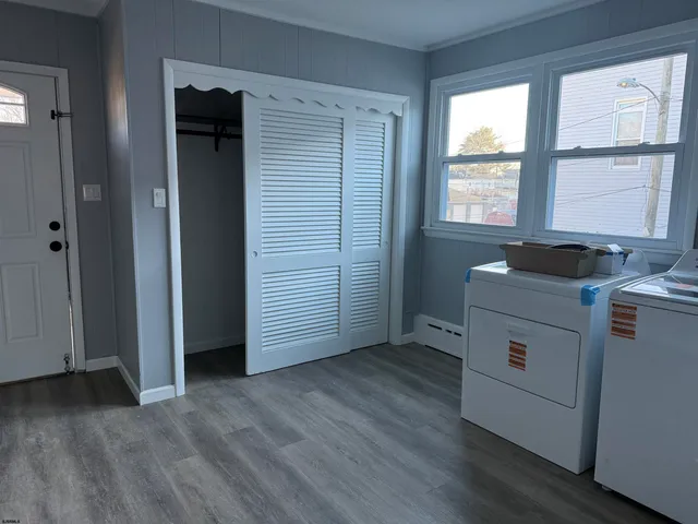 a view of a kitchen with a window wooden floor and cabinet