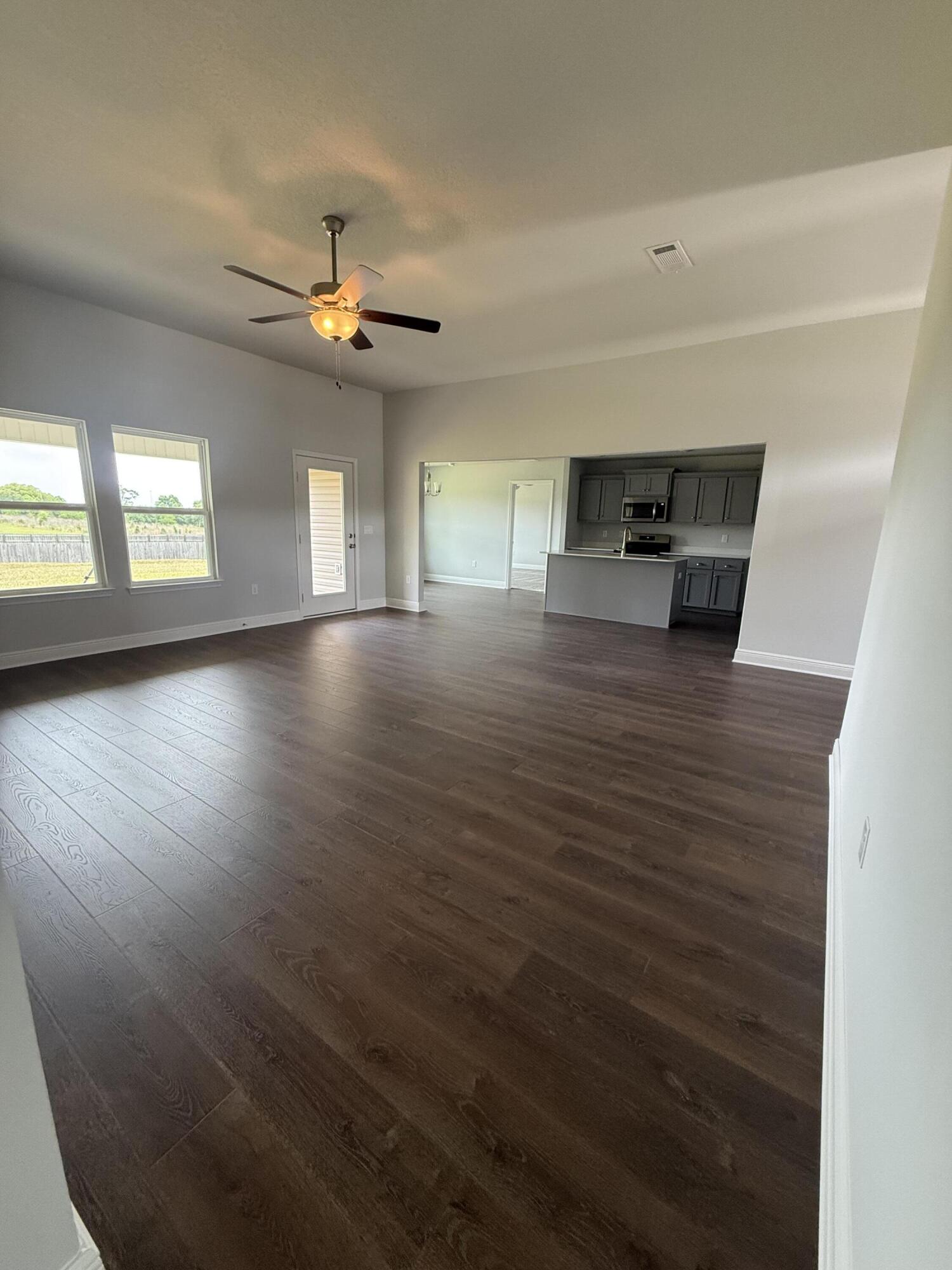 6004 Crocket Cove Crestview, FL 32539 - Photo 6 of 24 wooden floor in an empty room with a window
