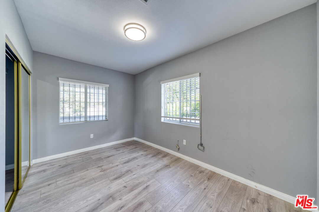117 South Virgil Avenue Los Angeles, CA 90004 - Photo 18 of 33 an empty room with wooden floor and windows