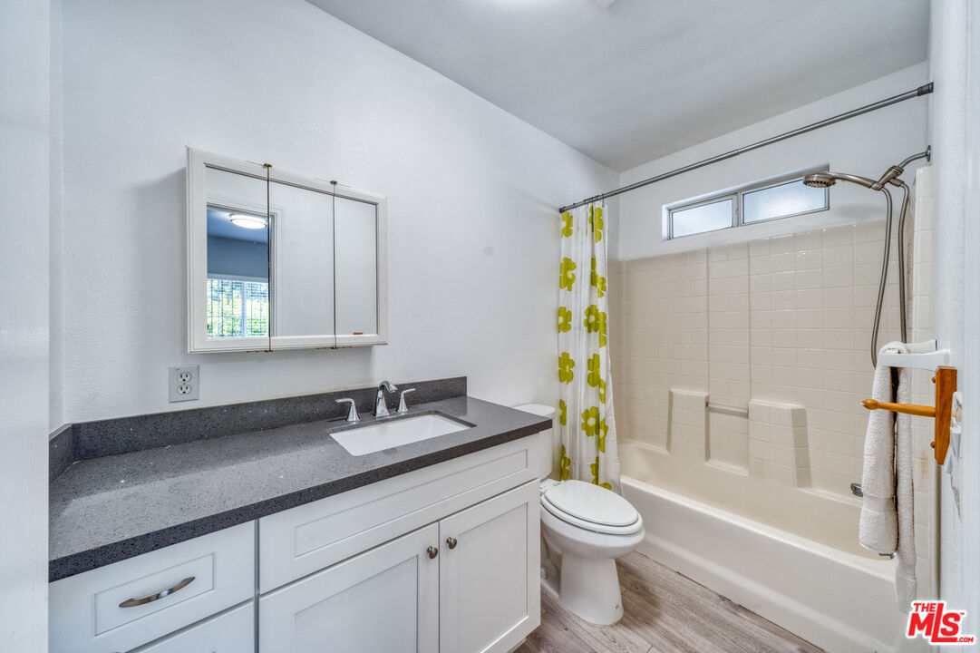 117 South Virgil Avenue Los Angeles, CA 90004 - Photo 20 of 33 a bathroom with a granite countertop sink toilet and shower