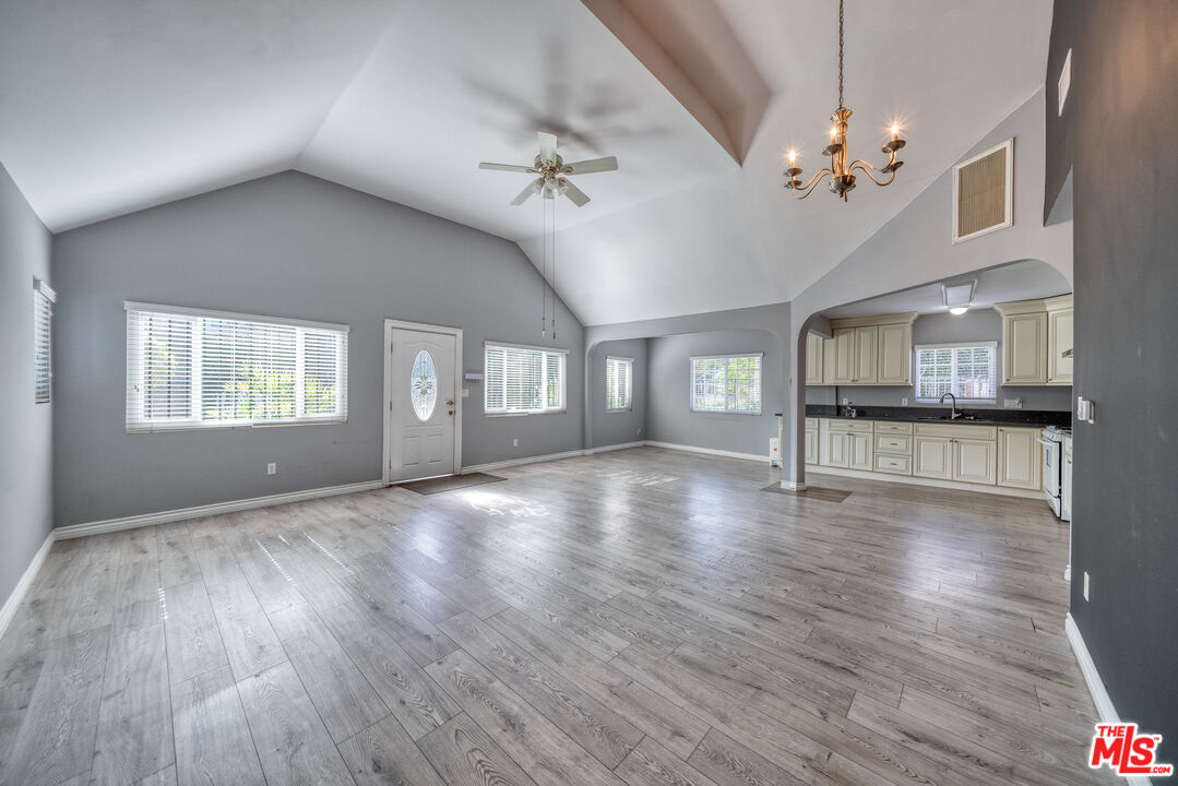 117 South Virgil Avenue Los Angeles, CA 90004 - Photo 2 of 33 a view of an empty room with wooden floor and a kitchen