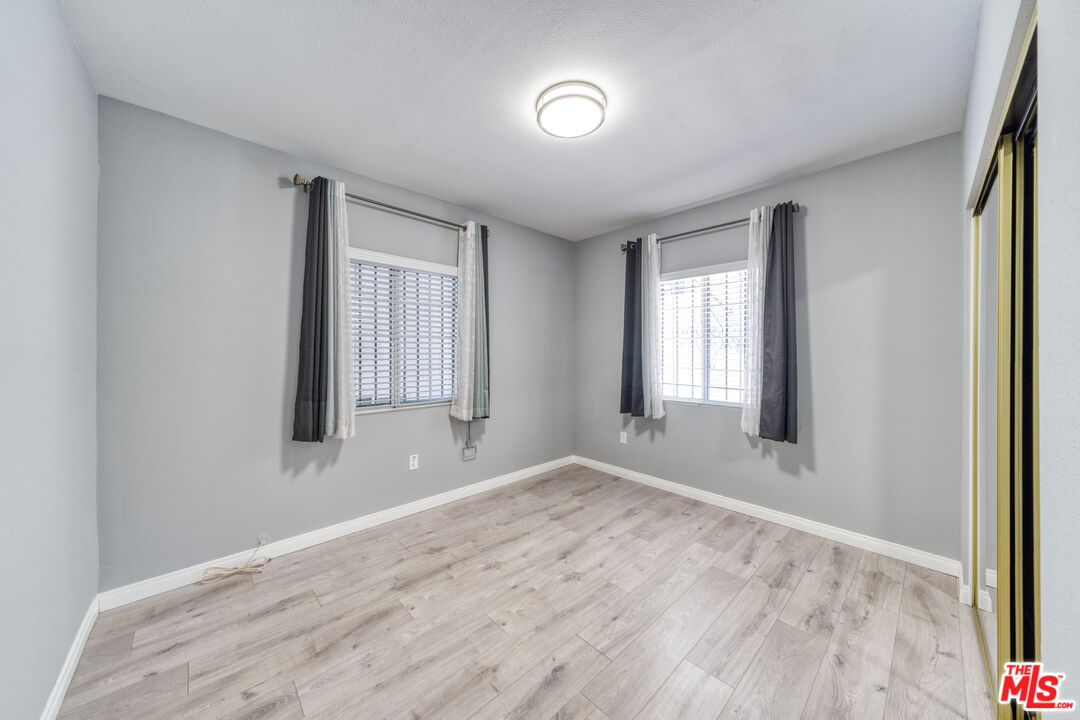 117 South Virgil Avenue Los Angeles, CA 90004 - Photo 22 of 33 a view of an empty room with wooden floor and a window
