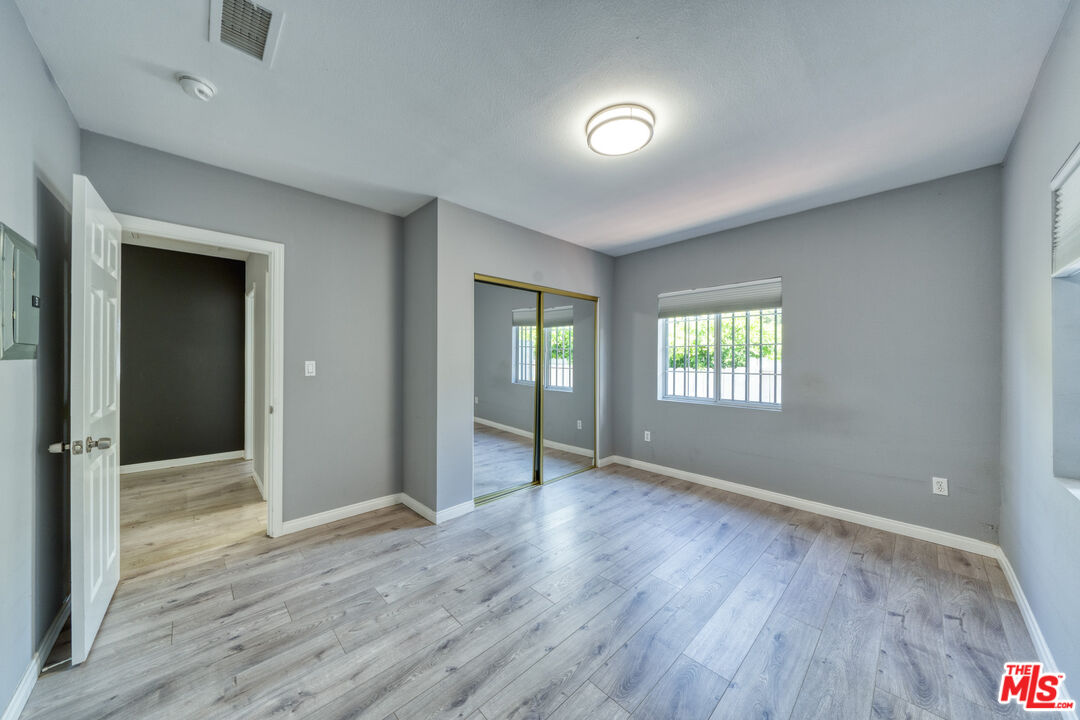 117 South Virgil Avenue Los Angeles, CA 90004 - Photo 24 of 33 an empty room with wooden floor and windows