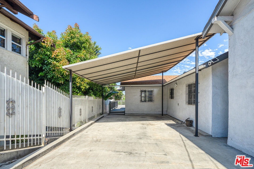 117 South Virgil Avenue Los Angeles, CA 90004 - Photo 26 of 33 a view of a house with a small yard and wooden fence