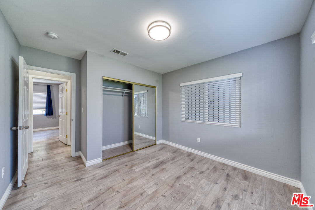 117 South Virgil Avenue Los Angeles, CA 90004 - Photo 5 of 33 a view of an empty room with wooden floor and a window