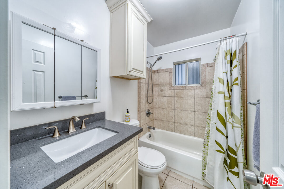 117 South Virgil Avenue Los Angeles, CA 90004 - Photo 6 of 33 a bathroom with a sink toilet a mirror and shower