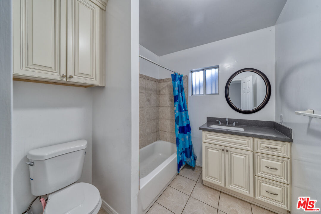 117 South Virgil Avenue Los Angeles, CA 90004 - Photo 7 of 33 a bathroom with a sink a toilet and a mirror