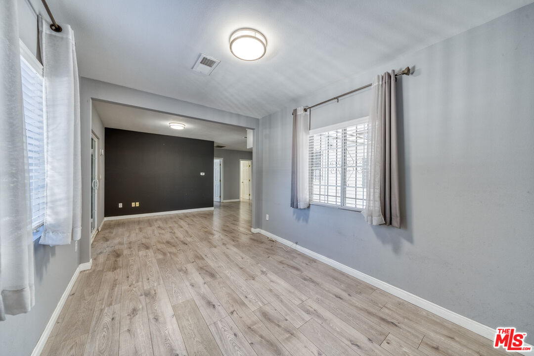 117 South Virgil Avenue Los Angeles, CA 90004 - Photo 8 of 33 a view of an empty room with wooden floor and a window