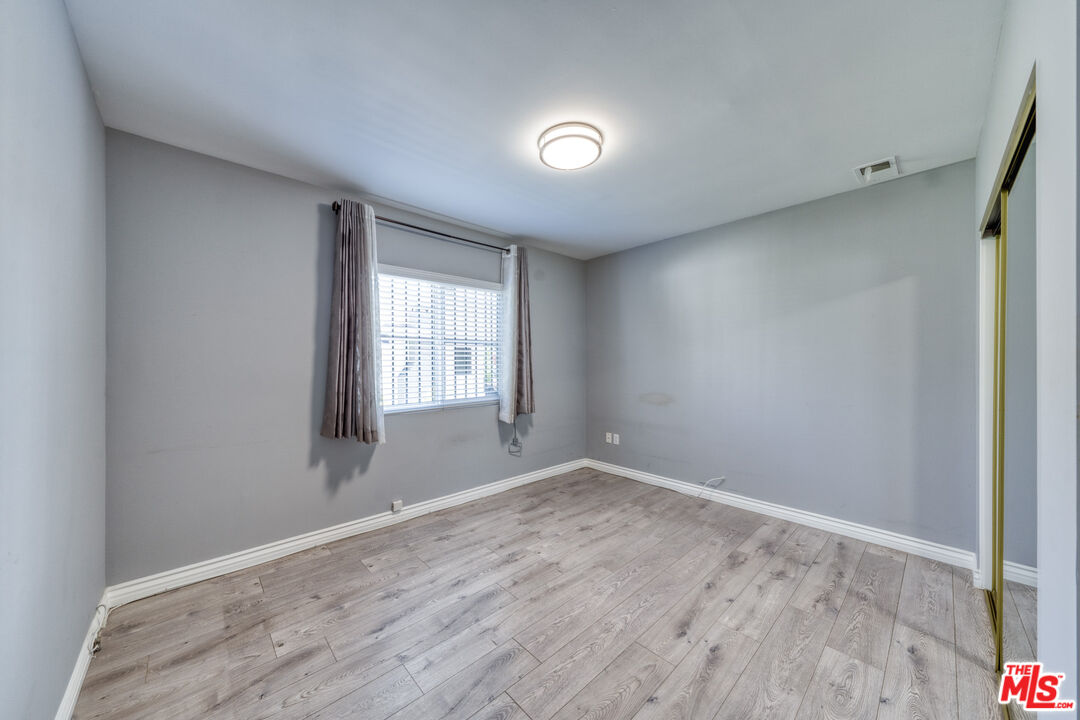 117 South Virgil Avenue Los Angeles, CA 90004 - Photo 9 of 33 a view of empty room with wooden floor and fan