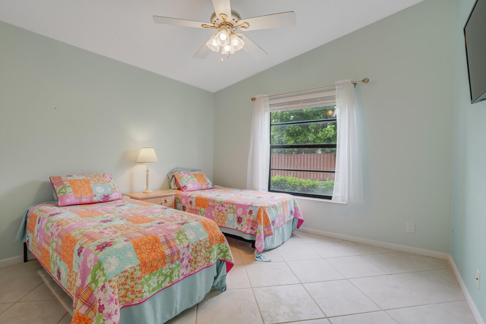 8020 Southeast Villa Circle Hobe Sound, FL 33455 - Photo 13 of 19 a bedroom with two beds and a window