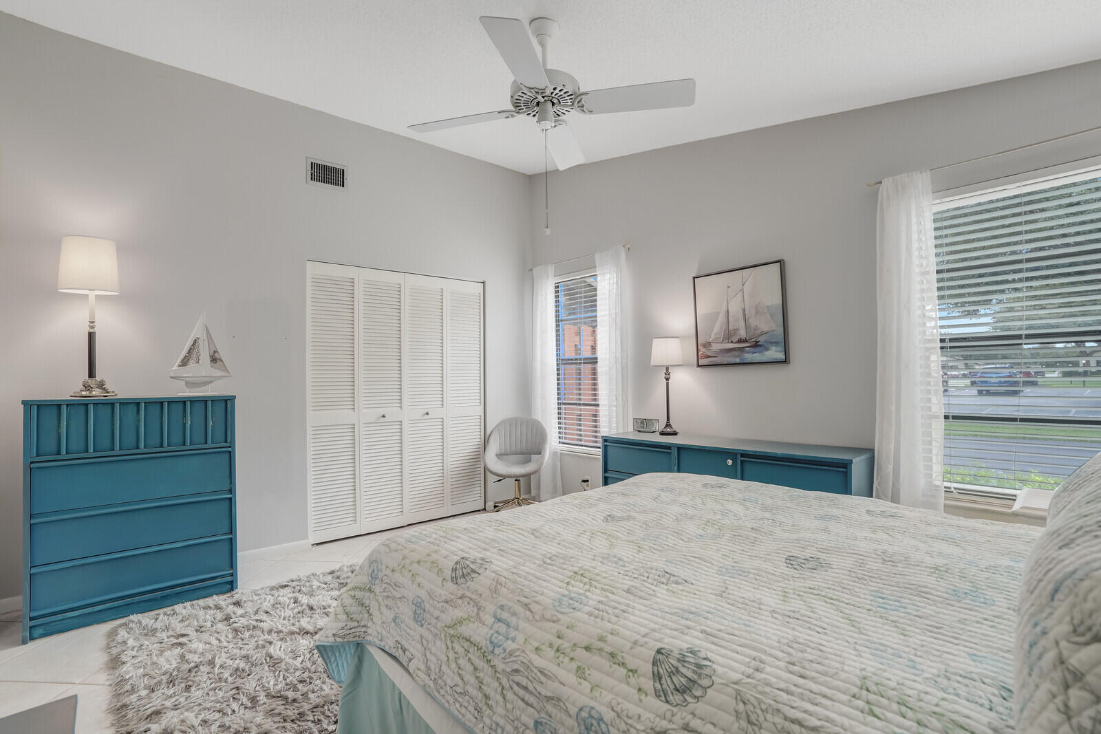 8020 Southeast Villa Circle Hobe Sound, FL 33455 - Photo 16 of 19 a bedroom with a bed and a dresser