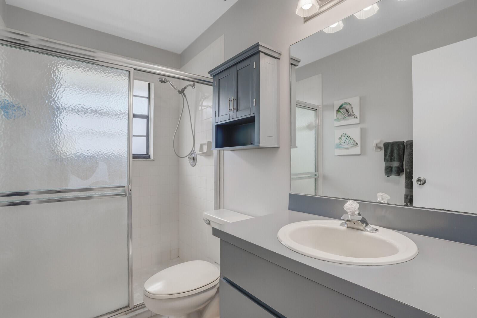 8020 Southeast Villa Circle Hobe Sound, FL 33455 - Photo 17 of 19 a bathroom with a sink toilet and shower