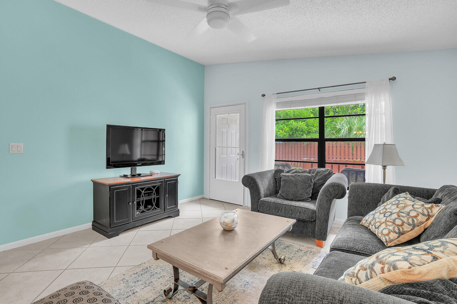 8020 Southeast Villa Circle Hobe Sound, FL 33455 - Photo 7 of 19 a living room with furniture and a flat screen tv
