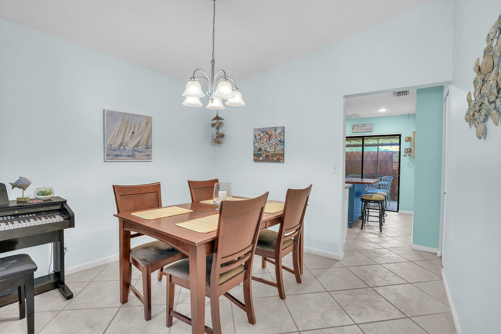 8020 Southeast Villa Circle Hobe Sound, FL 33455 - Photo 8 of 19 a view of a dining room with furniture and chandelier