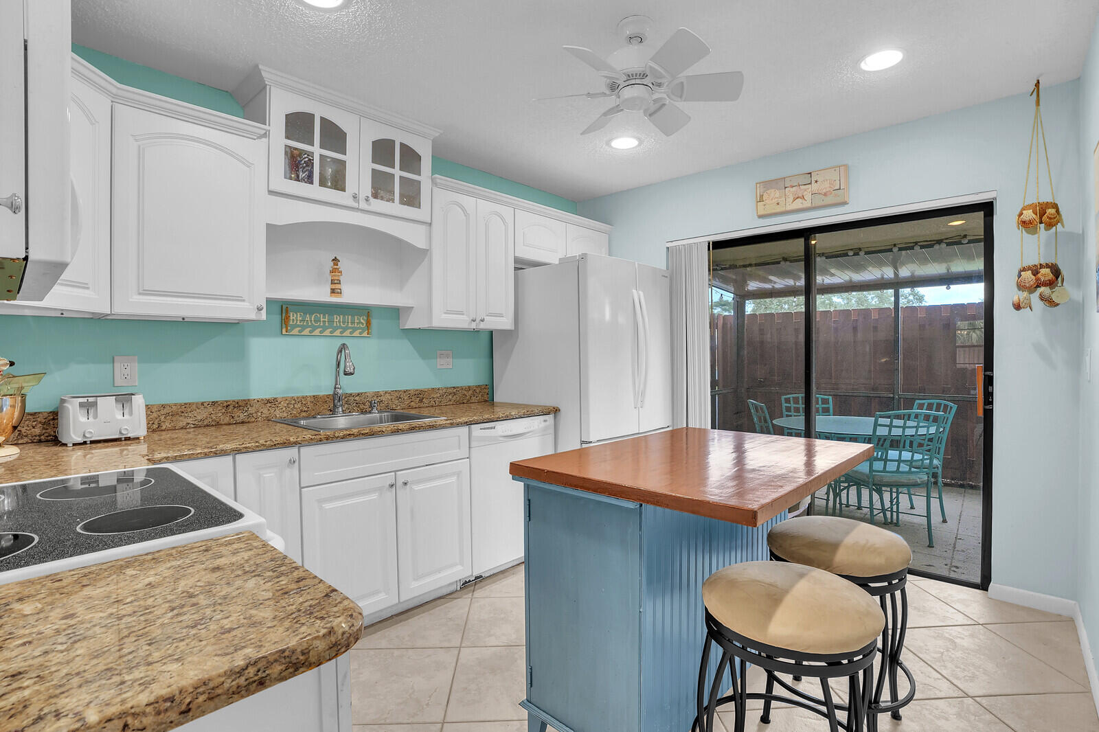 8020 Southeast Villa Circle Hobe Sound, FL 33455 - Photo 10 of 19 a kitchen with a stove a sink and a refrigerator