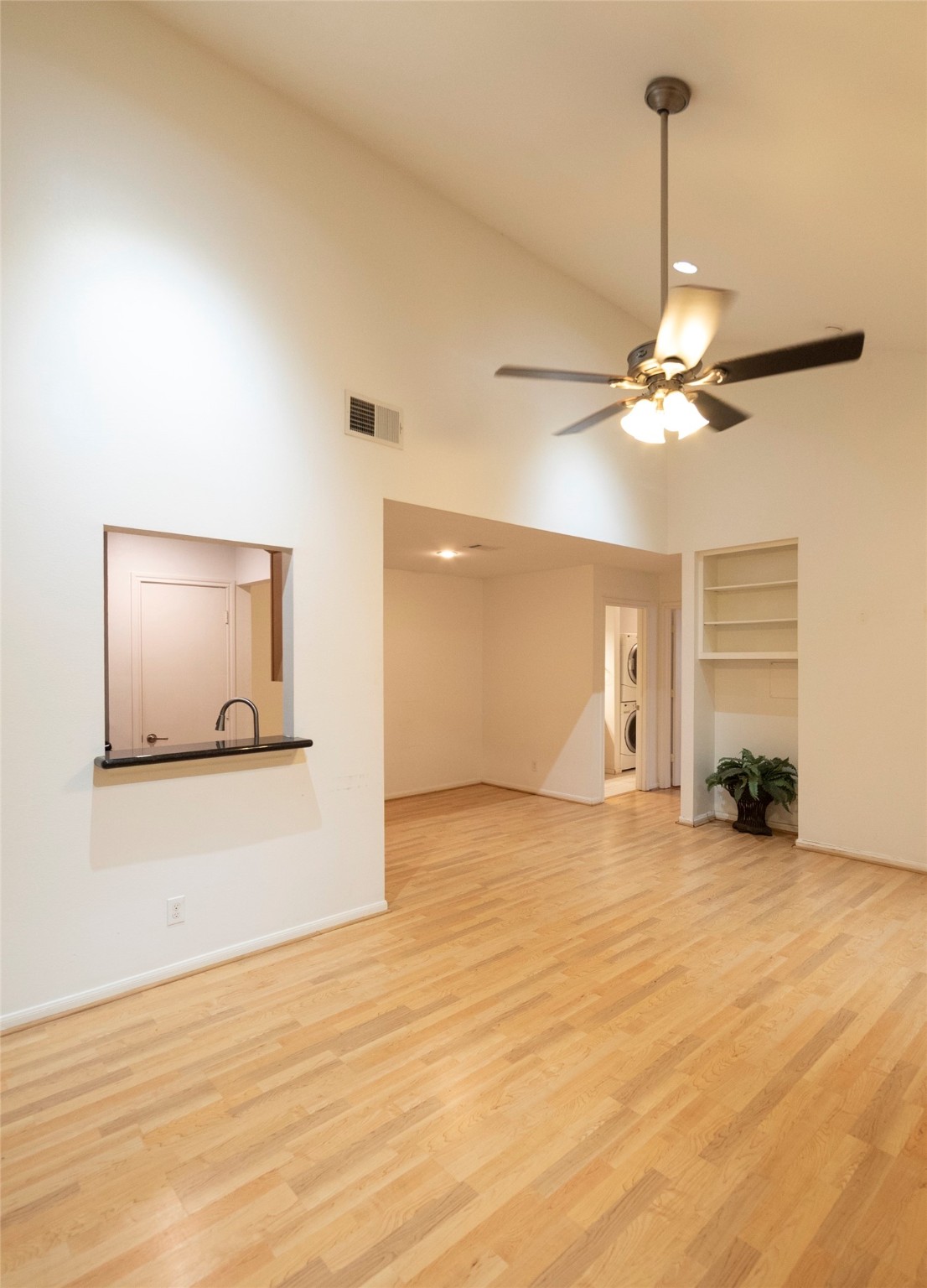 1100 Augusta Drive, Unit 76 Houston, TX 77057 - Photo 5 of 12 a view of a livingroom with a ceiling fan and wooden floor