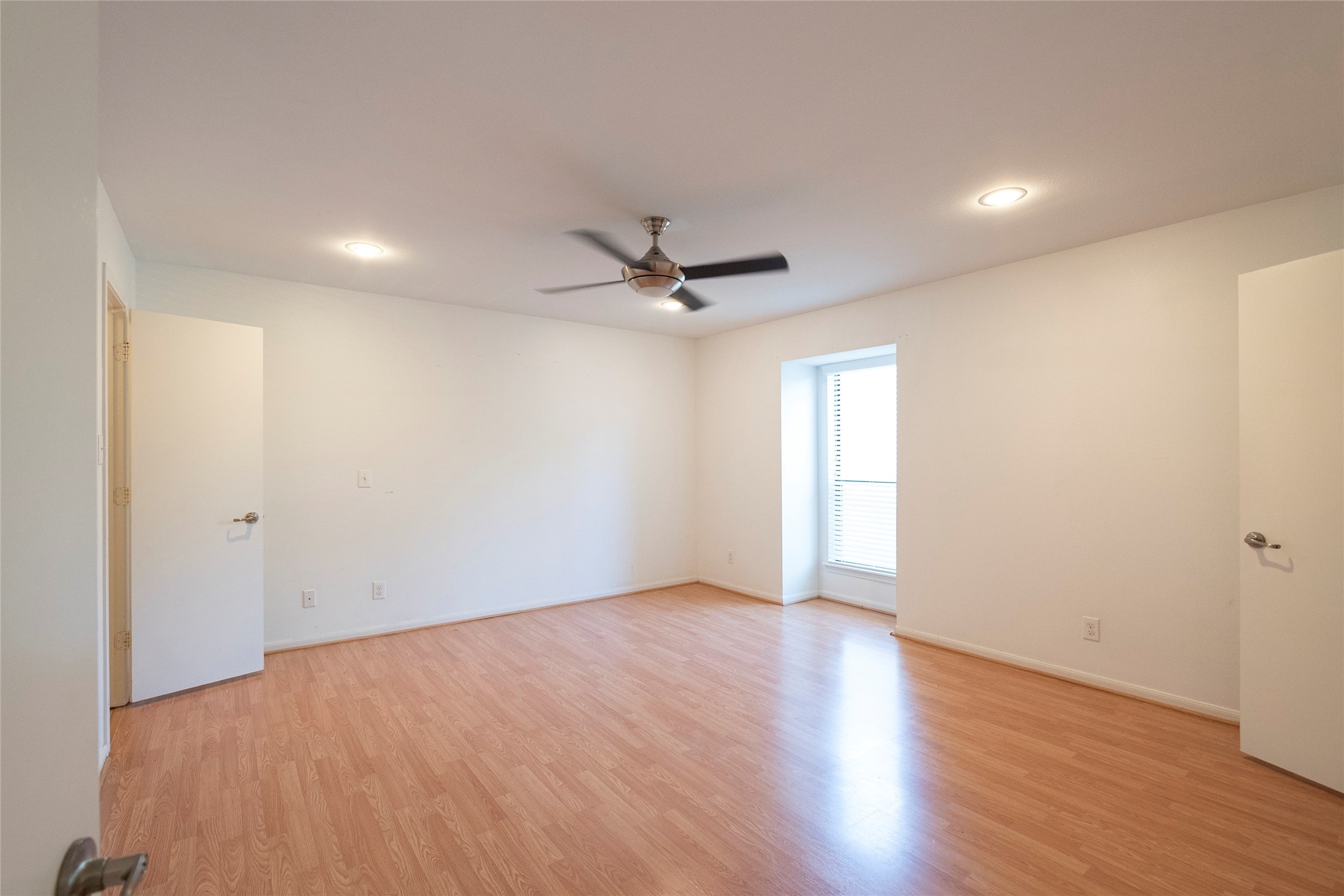 1100 Augusta Drive, Unit 76 Houston, TX 77057 - Photo 8 of 12 a view of an empty room with a ceiling fan