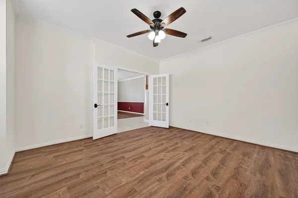 a view of an empty room with a ceiling fan