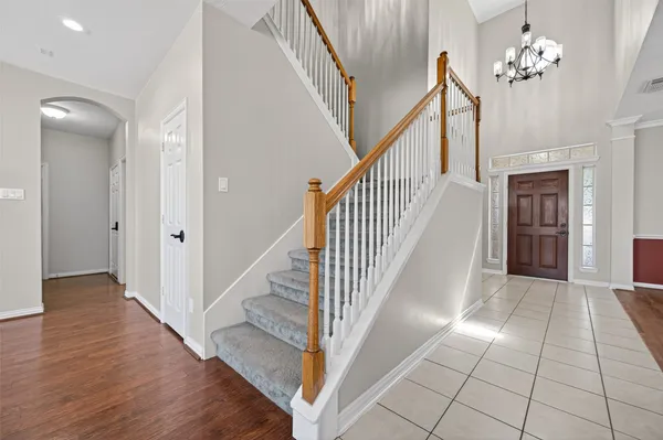 a view of entryway and hall with wooden floor