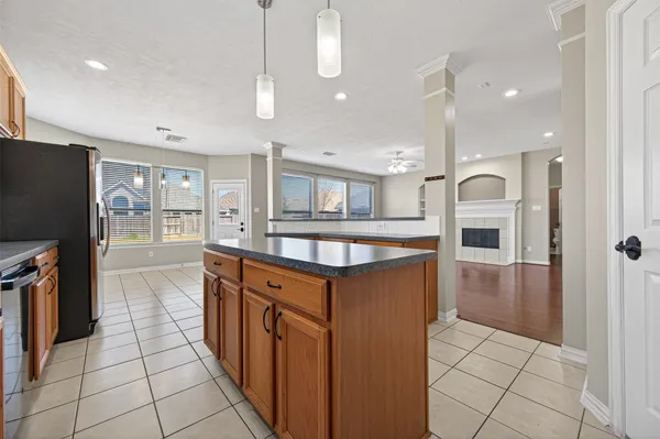a kitchen with stainless steel appliances granite countertop a refrigerator a sink and a wooden cabinets