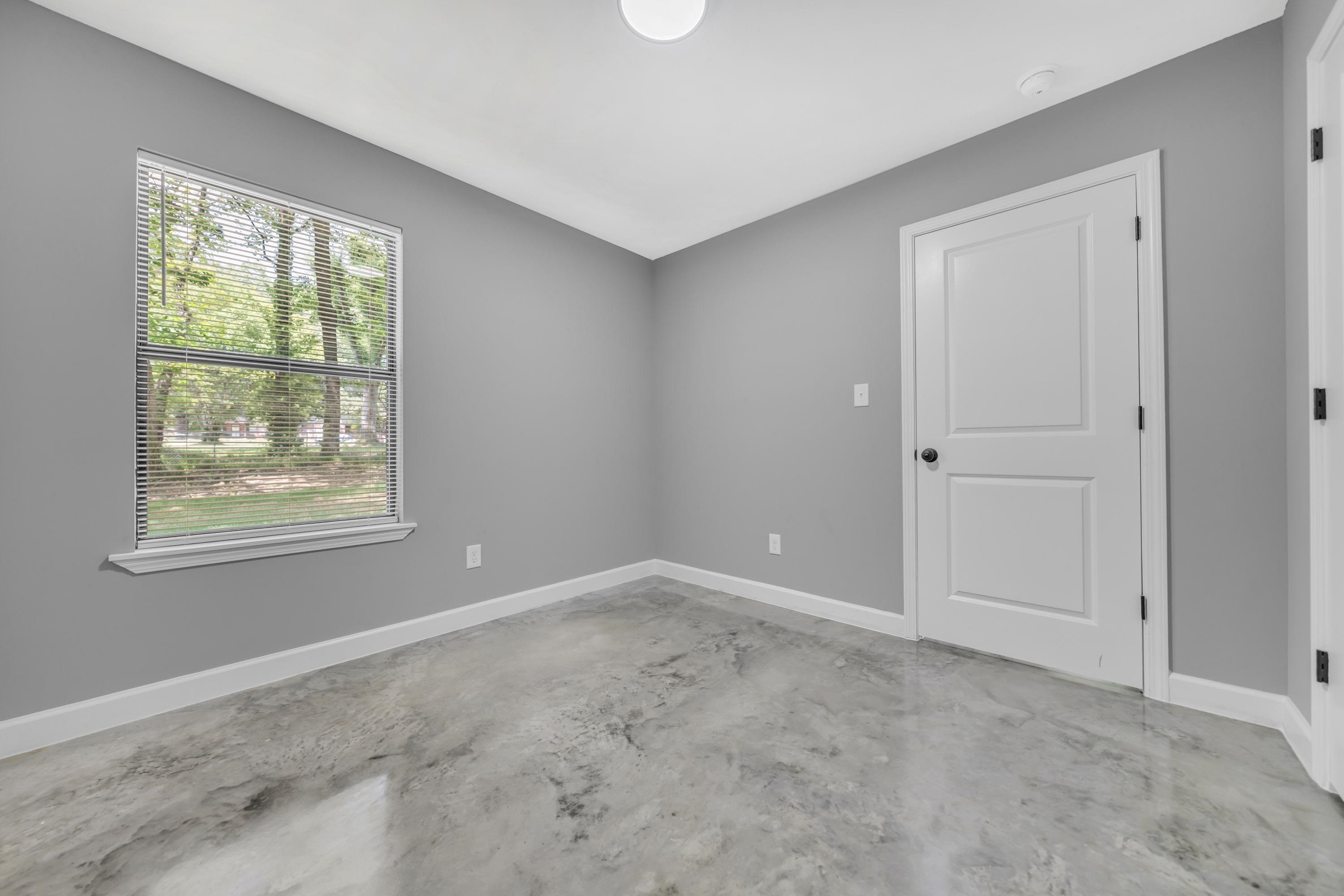 718 Hazelwood Road Memphis, TN 38109 - Photo 8 of 11 a view of an empty room with a window