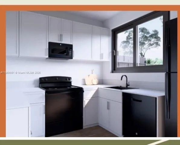 a kitchen with a sink a stove a microwave and cabinets