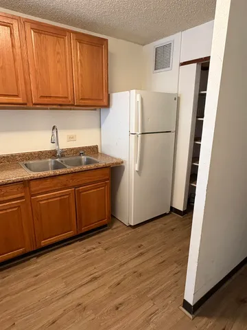 a white refrigerator freezer sitting inside of a kitchen