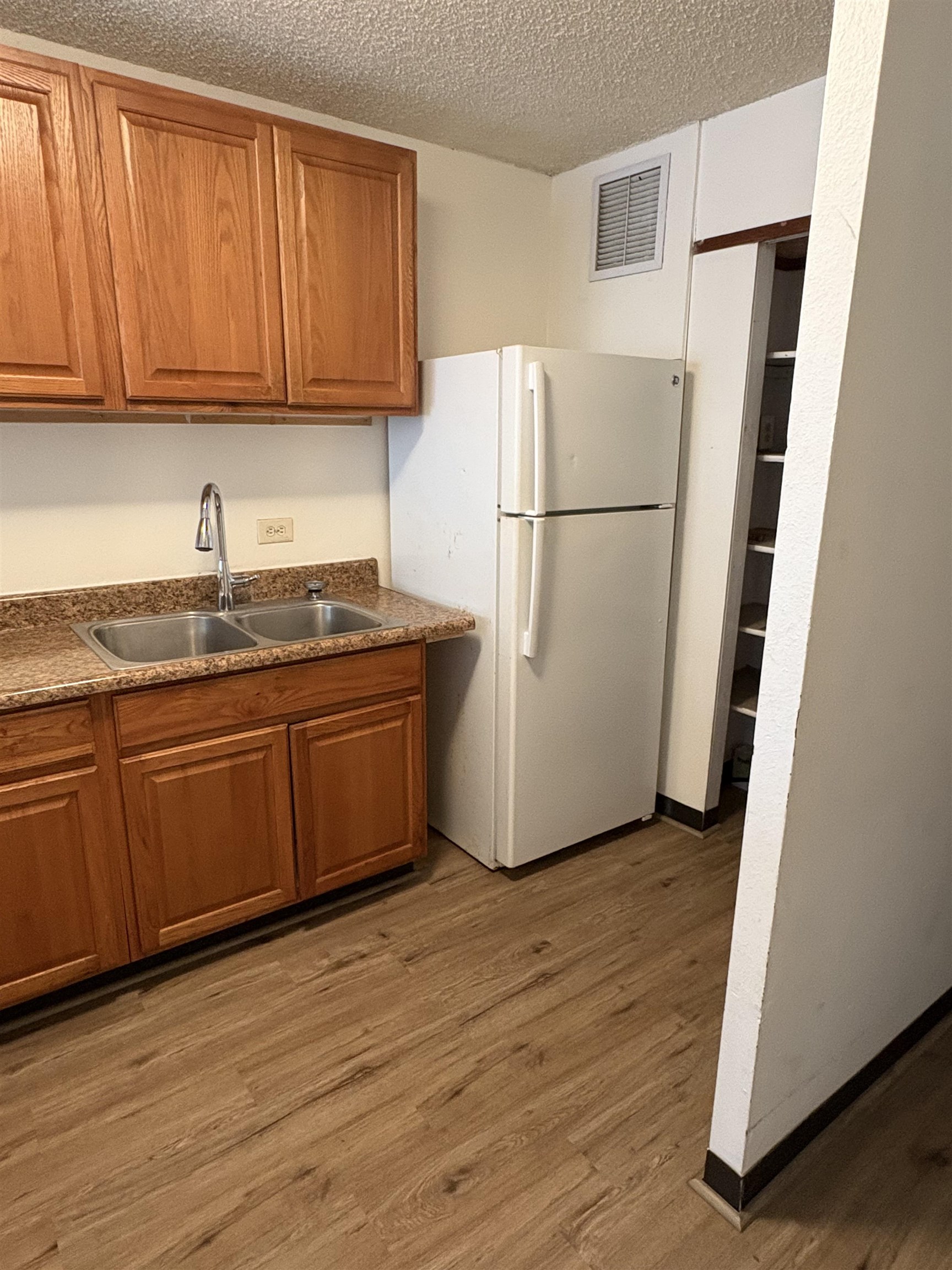a white refrigerator freezer sitting inside of a kitchen