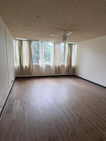 a view of room with hardwood floor and window