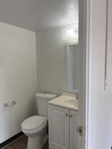 a white toilet sitting next to a bathroom sink