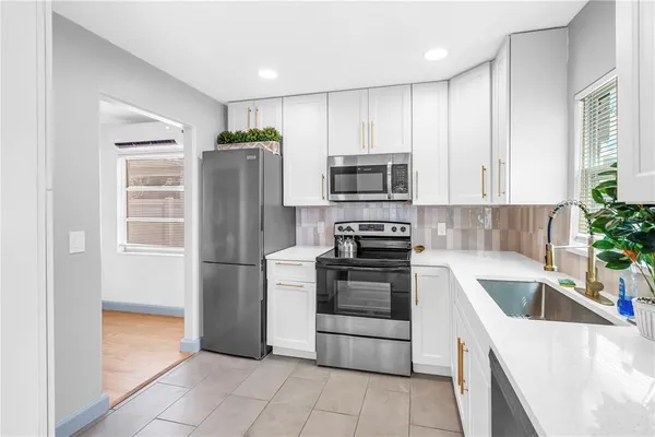 a kitchen with a refrigerator and a sink
