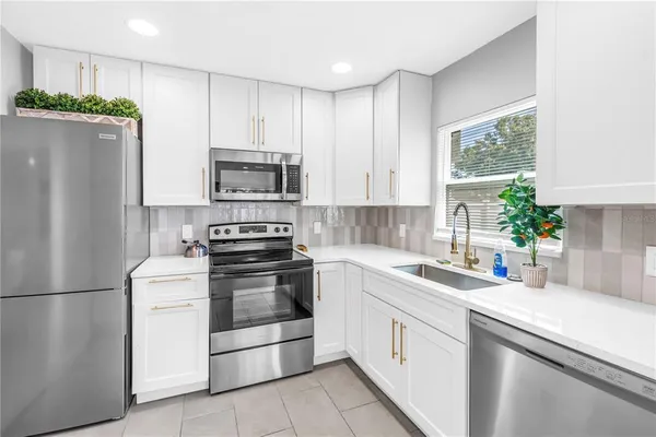 a kitchen with a white stove top oven and refrigerator