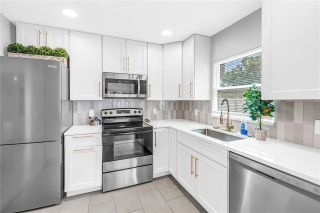 a kitchen with a white stove top oven and refrigerator