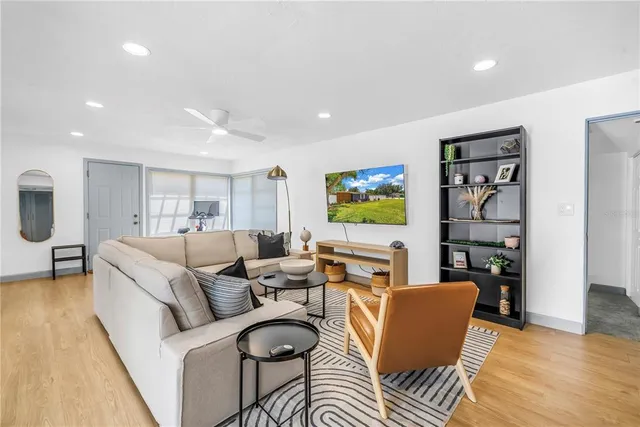 a living room with furniture and a mirror